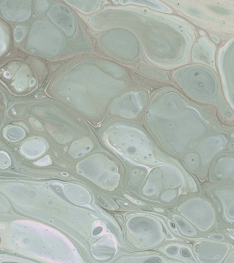 Abstract light green marbled texture with bubbles.