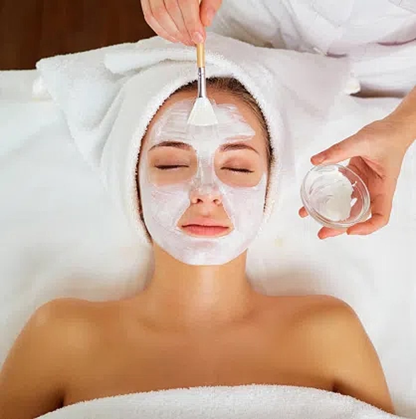 Woman receiving a facial treatment in spa.