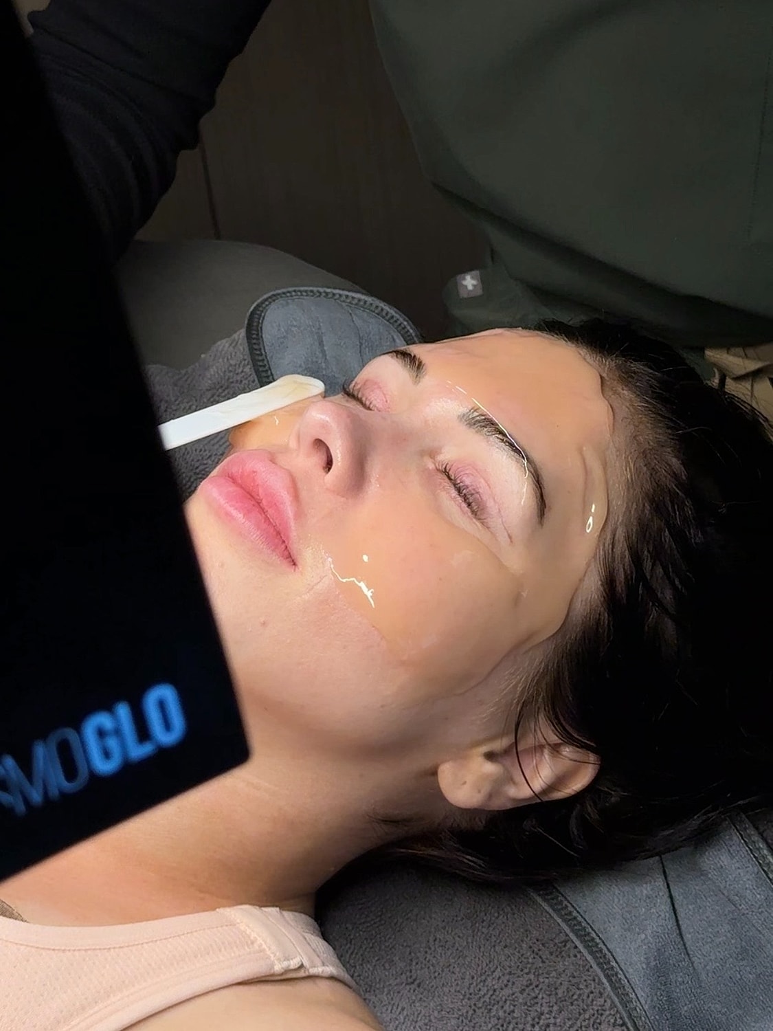 Woman receiving facial treatment in a salon.