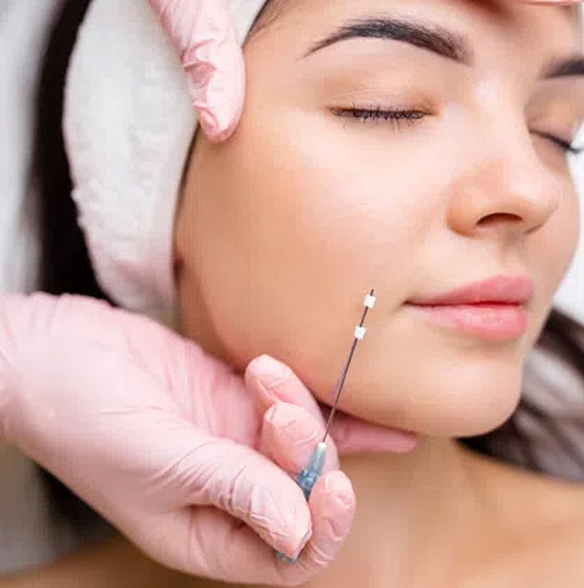 Facial treatment with needle and skincare professional.