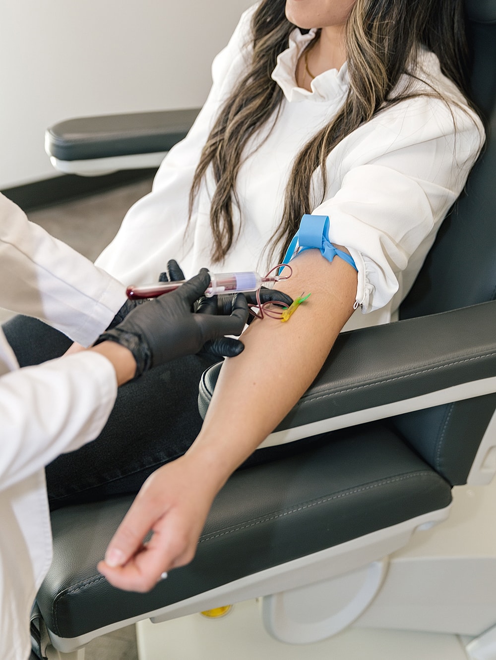 Patient receiving blood draw in medical setting.