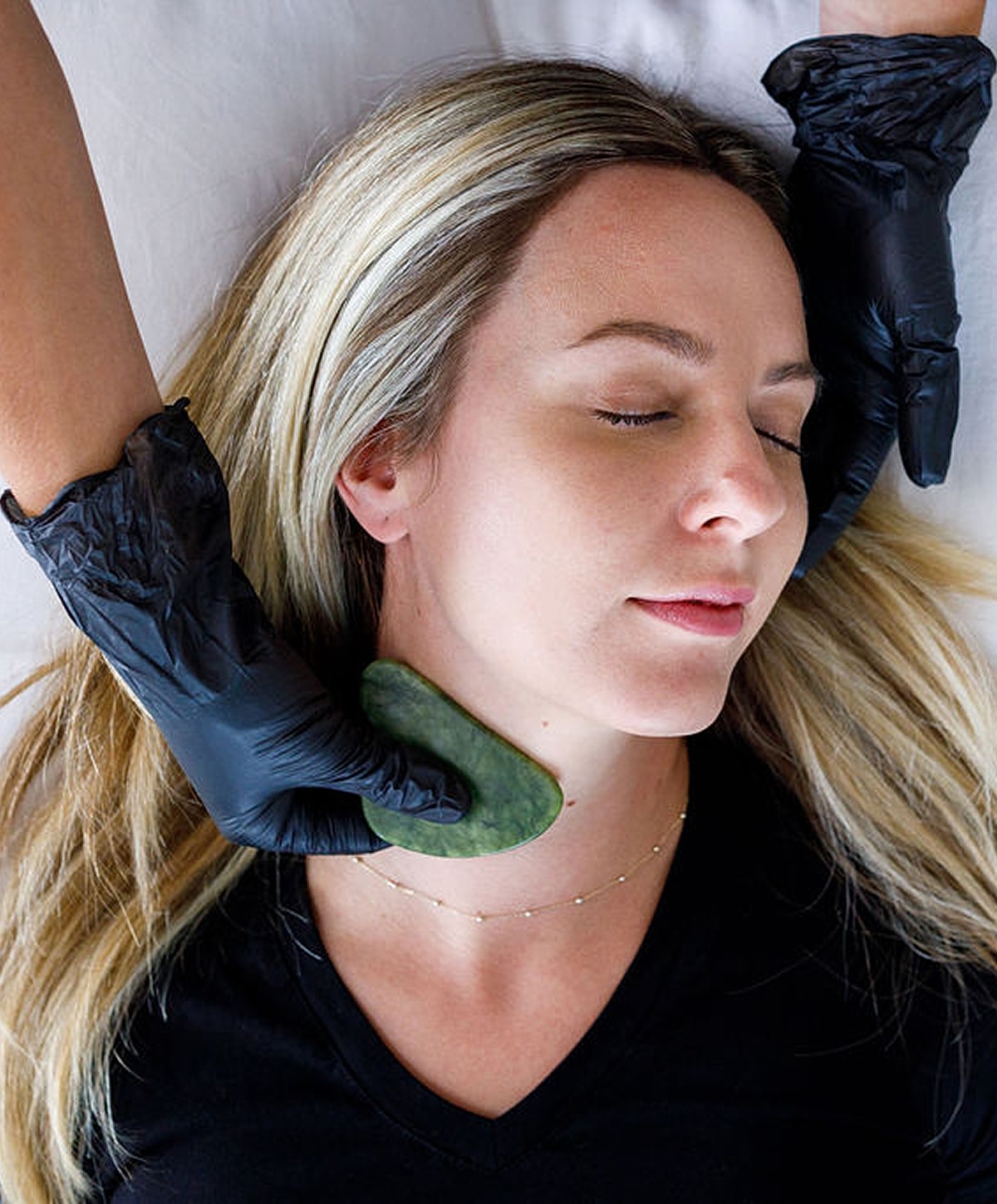 Woman resting with eyes closed, serene expression.