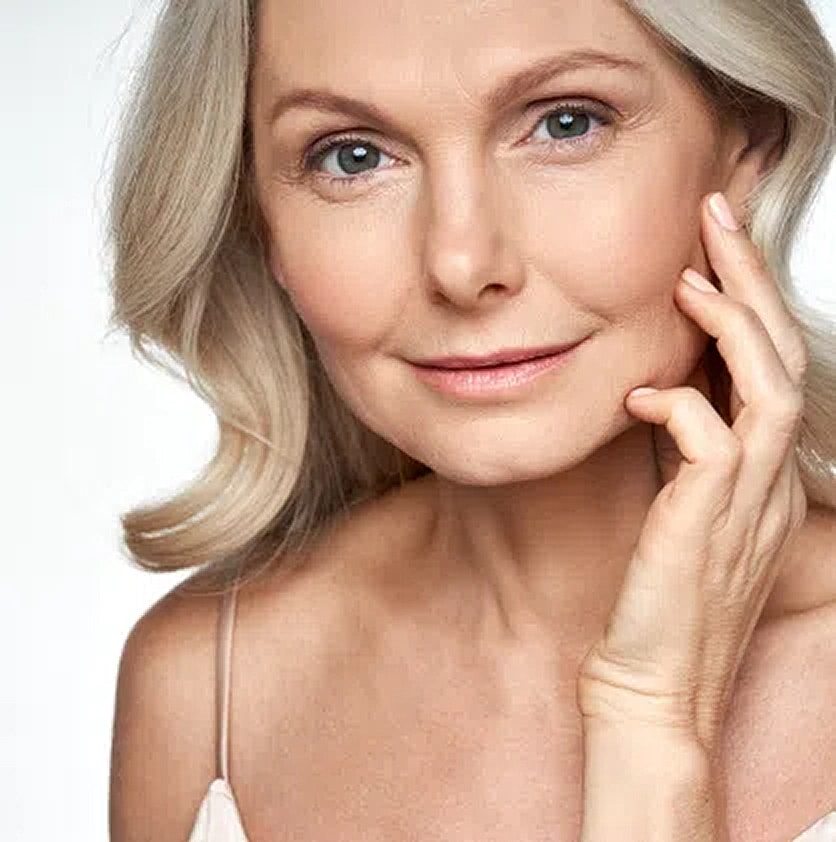Smiling older woman with long blonde hair.