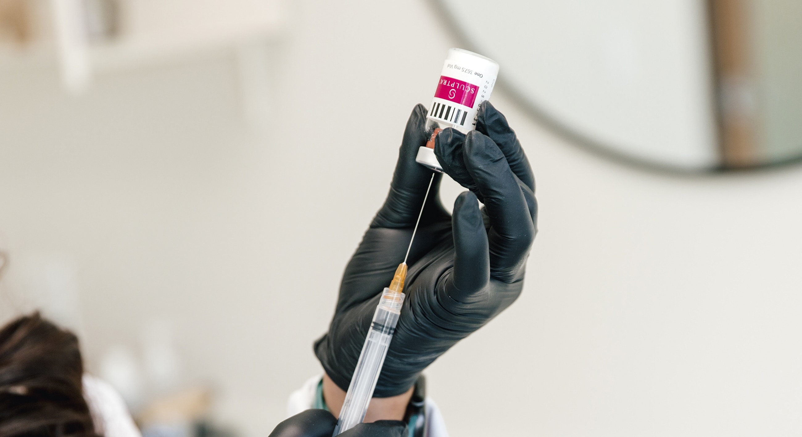 Preparing a syringe with medication vial.