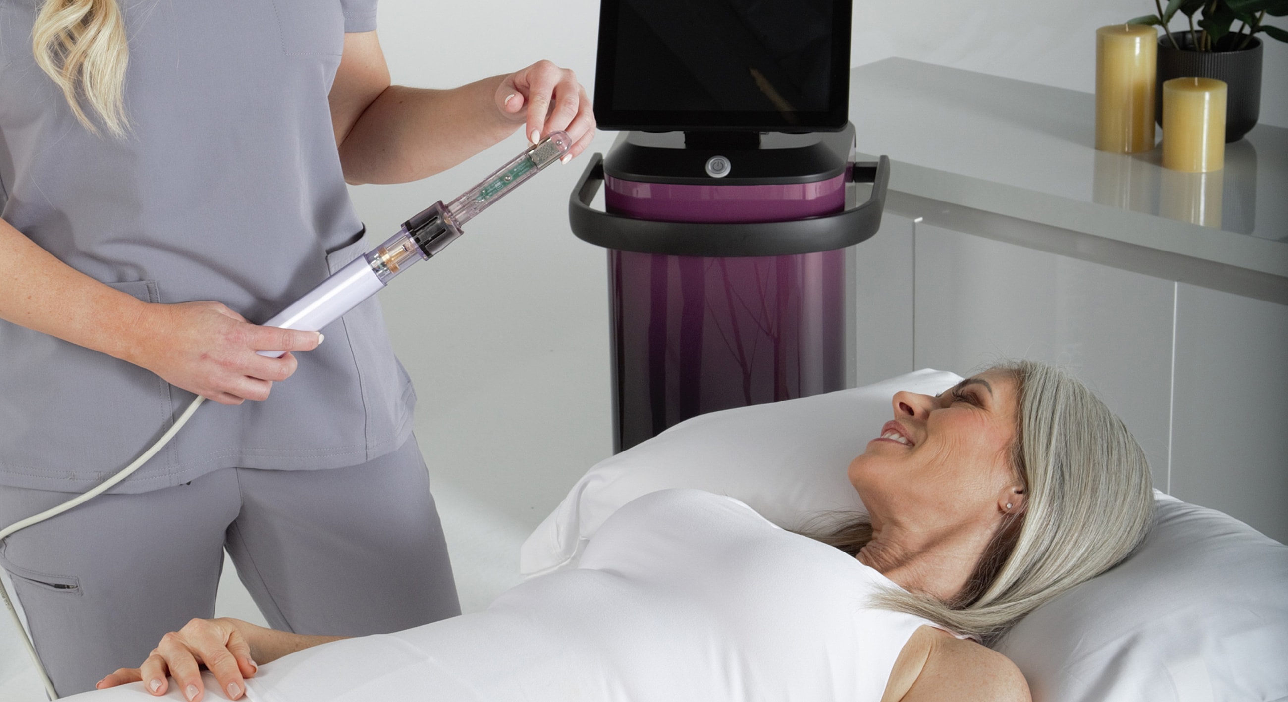 Medical professional performing treatment on smiling patient.